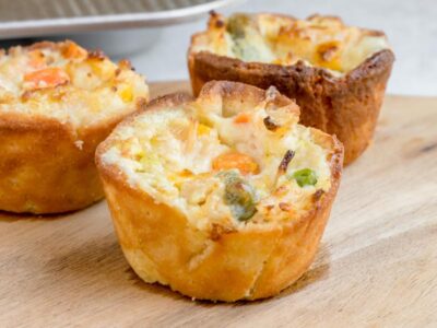 Mini keto chicken pot pies filled with creamy chicken and mixed vegetables in golden low-carb crusts.