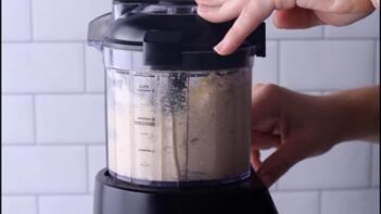 Keto pot pie dough mixed in a food processor until it begins to come together.