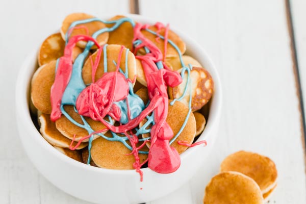 red and blue melted chocolate on mini keto pancakes