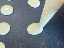 piping out keto pancake batter onto a griddle