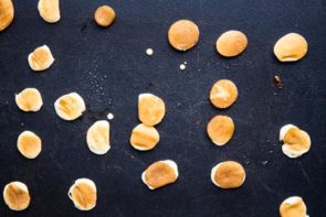 bunch of little mini low carb pancakes on a griddle cooking