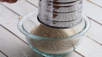 a bowl holding dry ingredients of keto snickerdoodle cookie cereal