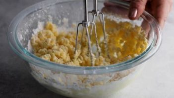 mixing buttercream with an electric mixer