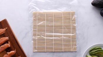 A bamboo mat covered with plastic wrap.