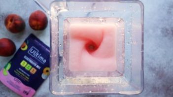 a pink drink blending in a blender