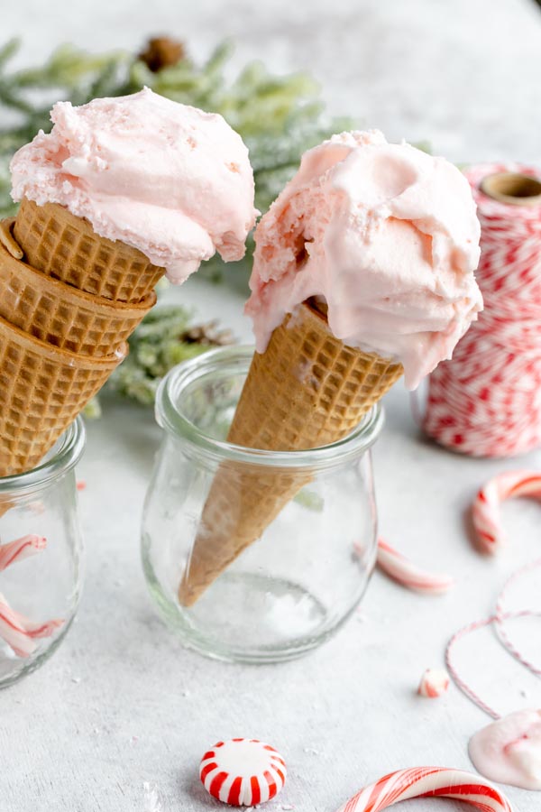 pink peppermint ice cream dripping from two cones