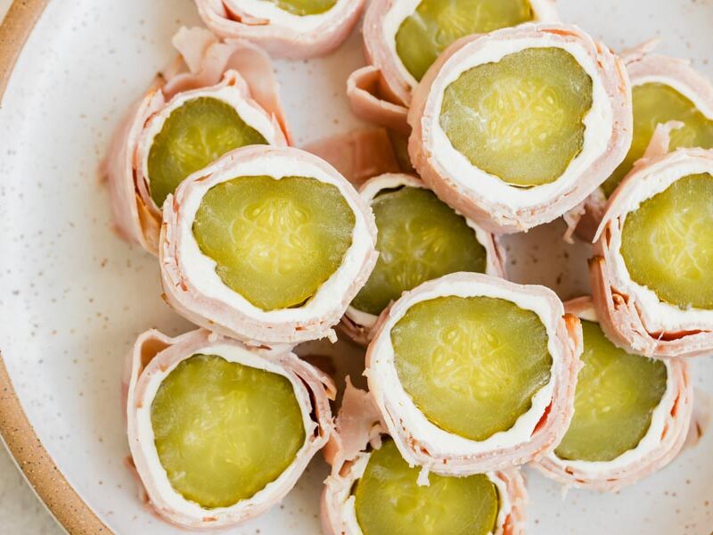Overhead view of pickle roll-ups showing the bright green pickles and cream cheese filling.