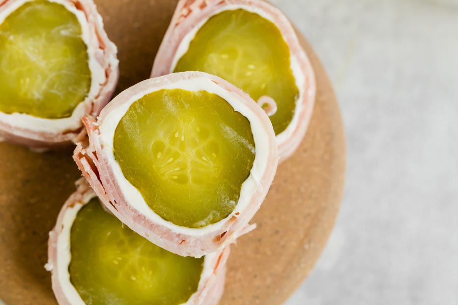 Close-up view of sliced pickle roll-ups showing the details of the pickle and cream cheese layers.
