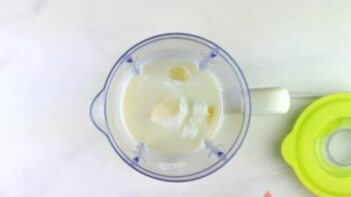 a blender with coconut milk and ice inside