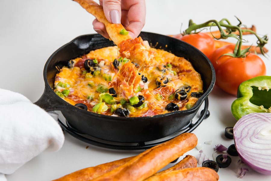 keto breadstick dipped in cheesy pizza hot dip