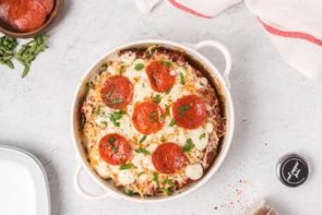 pizza toppings on a meatloaf with red pepper flakes around