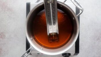 A thermometer in a saucepan with oil inside.