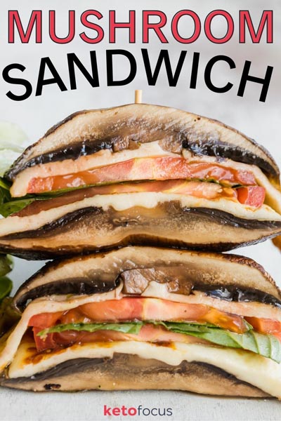 Two halves of a portobello mushroom sandwich stacked on each other filled with tomato, basil and cheese.