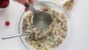 pouring in clear vanilla syrup into the granola bar mixture