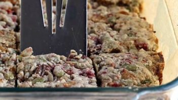 cutting into granola bars with a spatula