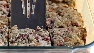 cutting into granola bars with a spatula