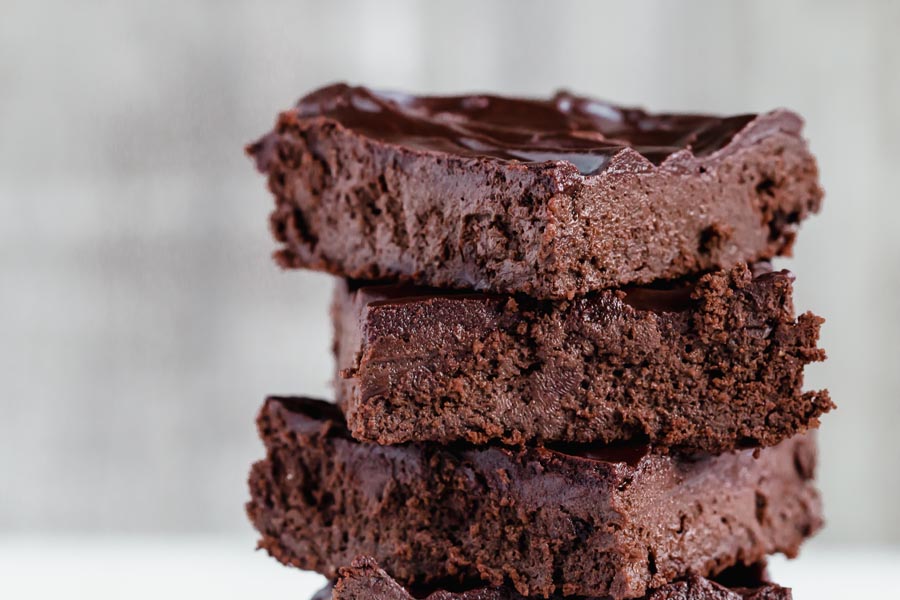close up stack of chocolate brownies with keto frosting