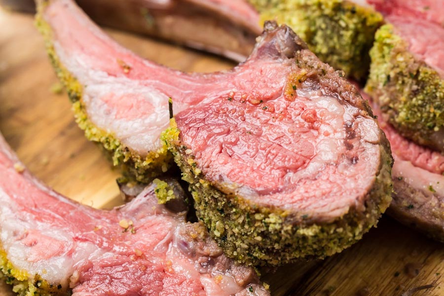 juicy and tender lamb rack on a cutting board