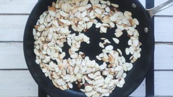 sliced almonds toasting in a skillet