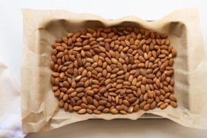 almond on a baking tray lined with parchment paper