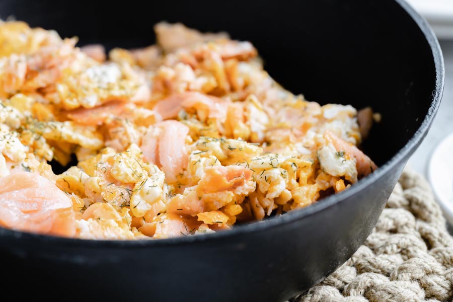 fluffy eggs in a skillet with smoked salmon flakes mixed in
