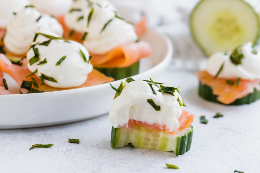 a bite out of a cream cheese, salmon cucumber bite