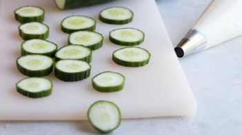 a bunch of sliced cucumbers on a cutting board