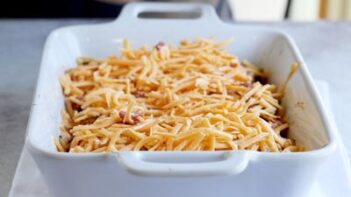 cheddar cheese shreds in a casserole dish