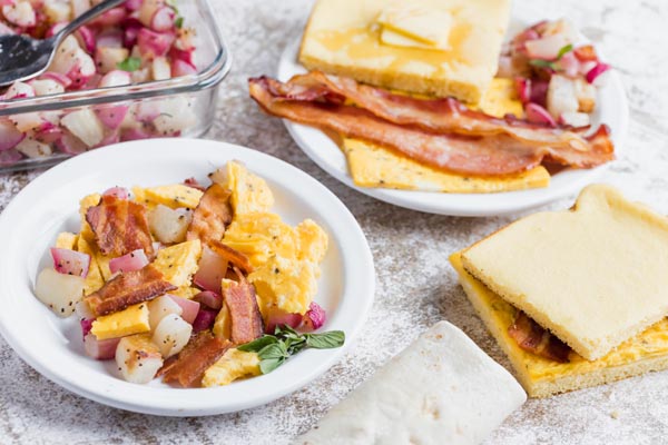 breakfast plates with scrambles, bacon, sandwiches