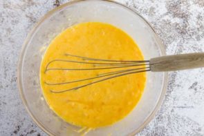 whisked eggs in a glass bowl with a whisk