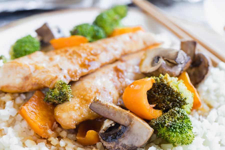 plump vegetables on a plate with chicken and riced cauliflower