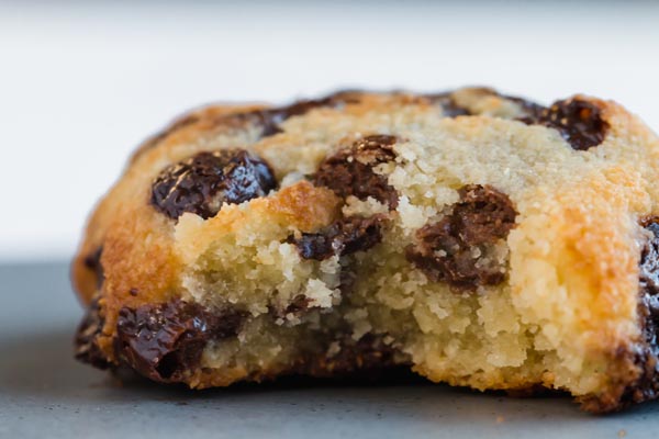 keto chocolate chip cookie cooked in the air fryer with a bite taken out