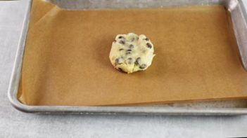 chocolate chip cookie for one on a parchment lined baking tray