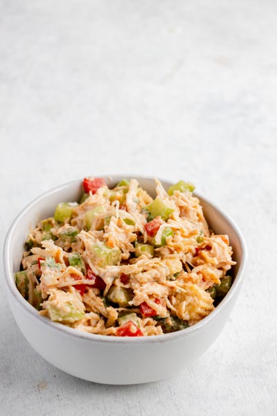 A bowl of high-protein Southwest chicken salad served on a white background.