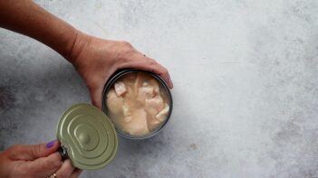 An opened can of canned chicken ready to be drained and used in the Southwest chicken salad recipe.
