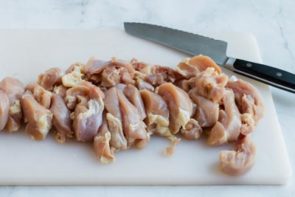 slicing up chicken thighs for kebabs