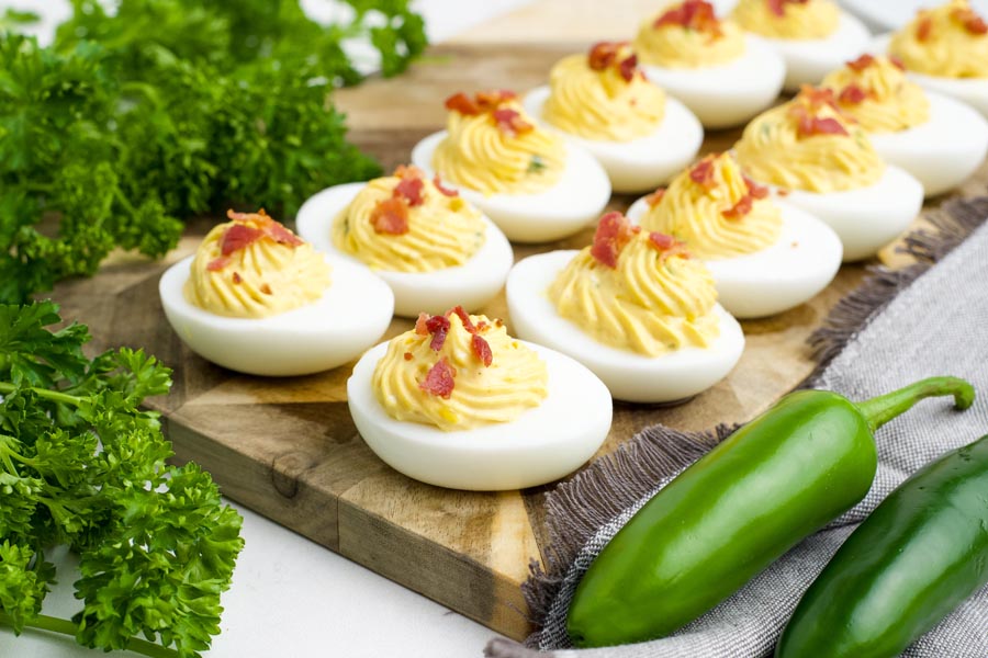 Deviled eggs filled with jalapenos and topped with crispy bacon.