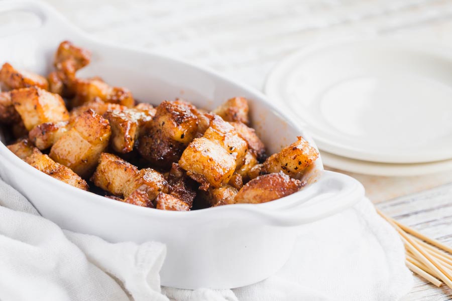 a small dish with bites of pork belly in them