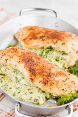 two stuffed chicken breasts on a skillet