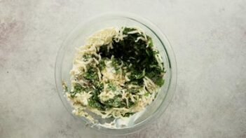 a bowl of spinach and cheese mixed together