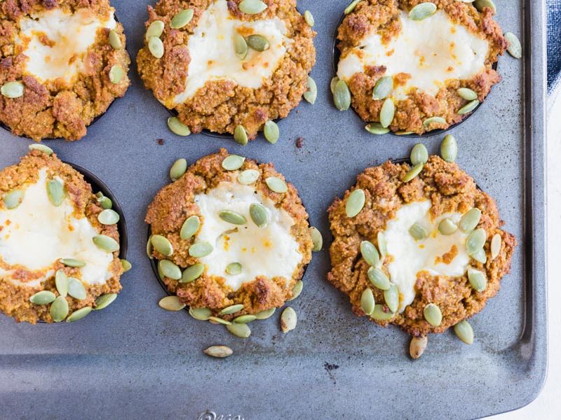 six cream cheese filled muffins in a baking tray