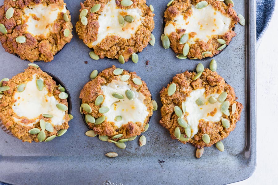 six cream cheese filled muffins in a baking tray