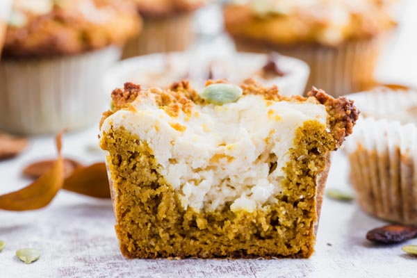 a pumpkin muffin filled with cream cheese sliced in half