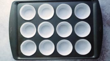 white muffin liners in a 12 cup muffin pan