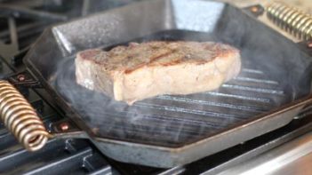 cooking a steak in a skillet
