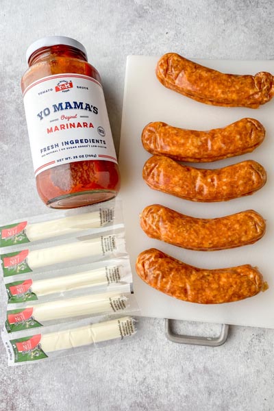 a jar of marinara, 5 italian sausages and a package of string cheese