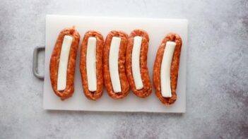 five sausages each stuffed with a white mozzarella cheese stick in the center