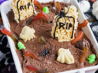 a chocolate cake decorated like a graveyard with gummies and chocolates