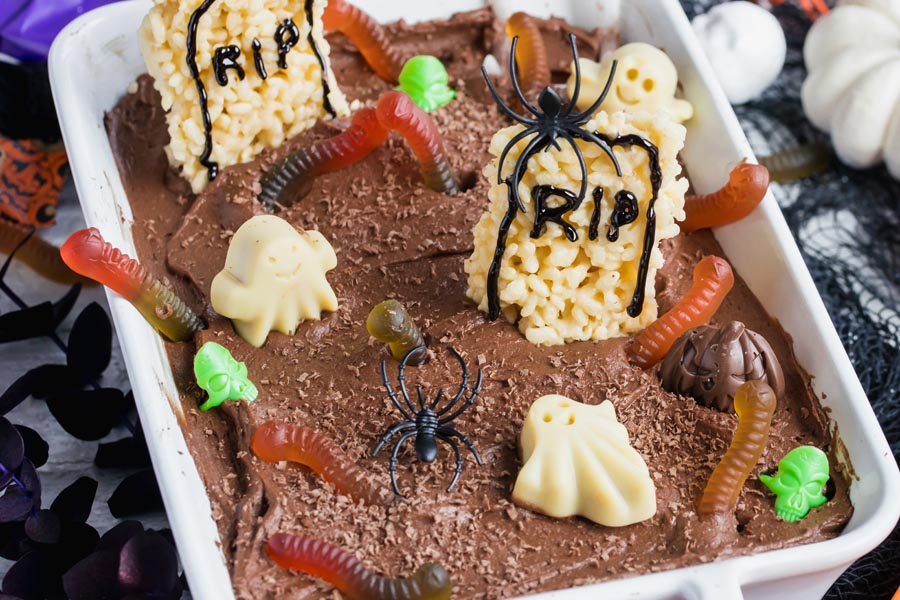 a chocolate cake decorated like a graveyard with gummies and chocolates