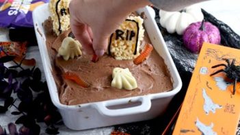 decorating a graveyard scene on a cake